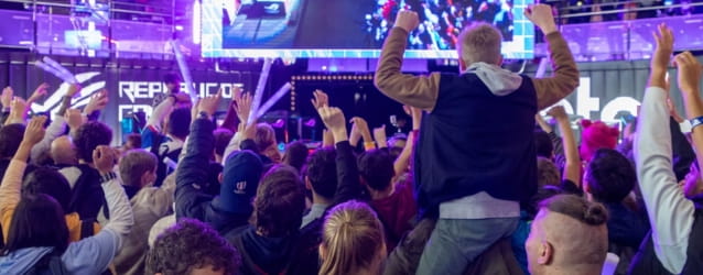 Happy crowd with adults and a child on an adult's shoulders at Paris Games Week 2023
