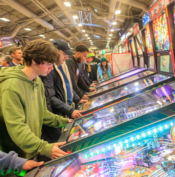 Photo of young people playing pinball at Paris Games Week